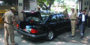 Policemen check a car at the Delhi High Court in New Delhi on Thursday. 
