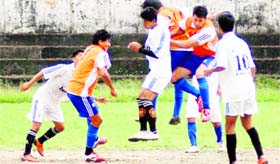 Players of Akranta Club (in orange) and those of Wills Youth Club (in white) vie for the ball in a Lala Nemi Dass Memorial District Football League match played in Dehradun on Thursday.
