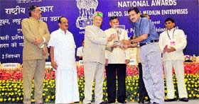 Union Minister of Micro, Small and Medium Enterprises Virbhadra Singh honours Praveen Jain, chief executive officer of Vaiseshika Electron Devices, Ambala Cantt, with the national award at the Vigyan Bhavan in New Delhi.
