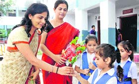 Schoolgirls present bouquets to their teachers on the occasion of the Teachers Day in Rohtak.