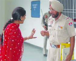 Pooja argues with her second husband sub-inspector Mangal Singh in the Division No 3 police station in Jalandhar 