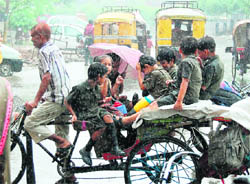 Children, returning from school, caught in the sudden downpour in Amritsar 