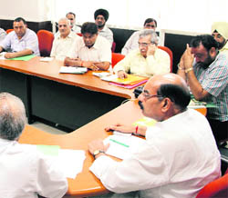 Mahinder Bhagat (extreme right) chairs a meeting of MC officials and councillors in Mayor's meeting hall in Jalandhar on Thursday. 