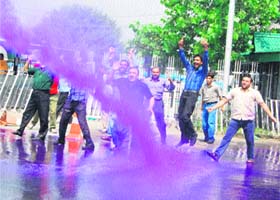 The police uses water cannon to stop striking employees from marching to Lal Chowk in Srinagar on Thursday