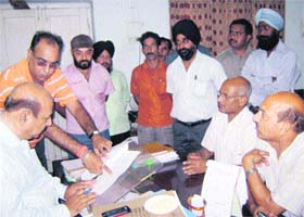 A delegation of parents hands over a memorandum to Chief Education Officer Natha Ram in Jammu on Thursday