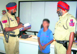 A juvenile being questioned by cops in Ludhiana