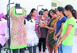 Girls take a look at the creations designed by students of Guru Nanak Girls College, Model Town, Ludhiana