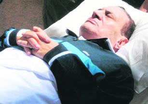Ousted Egyptian president Hosni Mubarak being wheeled into a Cairo courtroom