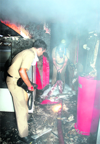 Firefighters douse a blaze at an ATM in Sector 23, Chandigarh, on Friday