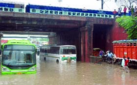 Submerged buses stand abandoned at an underpass near Welcome Metro station in New Delhi.