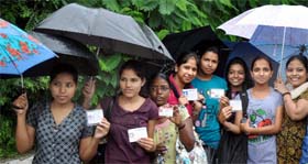 This bunch of students turn up to cast their votes amidst the downpour at Delhi University on Friday.