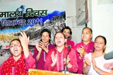 A group sings a song at a Himalaya Day function in Dehradun on Friday.