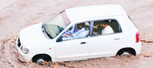 A car stuck in a whirlpool near the Patiala bus stand. 