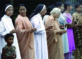 Citizens of Delhi pay tributes to the victims of the high court blast at a Gol Dakhana church in New Delhi on Saturday