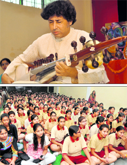 Sarod player Partho Sarothy gives a performance at a SPICMACAY programme at Doon International School in Dehradun on Saturday. Tribune photo: Vinod Pundir; and (below) Students of the school listen to the sarod recital