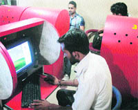 Youths surf the net at a cyber cafe in Jammu on Saturday. 