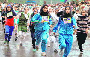 Girls take part in the first Kashmir marathon on the banks of the Dal Lake in Srinagar on Saturday. 