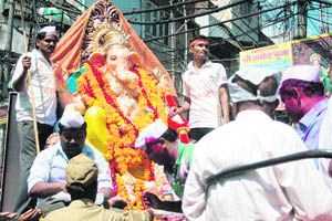 Devotees hold a procession before immersing Lord Ganeshas idol in the Tawi in Jammu