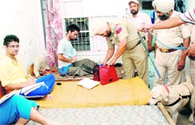 A policeman checks a bag of an outstation student at Phase III-B2 in Mohali on Sunday