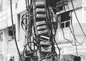 A maze of electricity wires on a pole poses a risk to the lives of residents