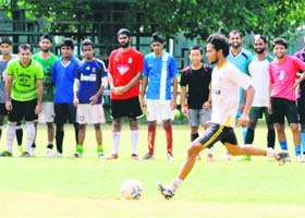 A player tries to score a goal during the selection trials for the PU Campus football team in Chandigarh on Sunday