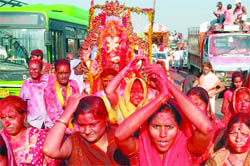 Devotees carry an idol of Lord Ganesha near ITO in New Delhi on Sunday. 