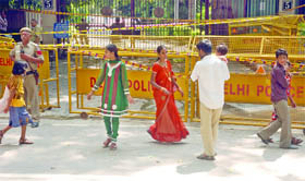 A family walks near the blast site outside the High Court in New Delhi on Sunday. 