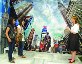 Girls admiring photographs of an exhibition at American Center in New Delhi on Sunday, to celebrate the Spirit of New York to mark the decade since the tragic events on September 11 in America. Tribune photo: Manas Ranjan Bhui