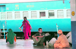 Passengers sit on the floor while waiting for their train at Jammu-Tawi Railway Station