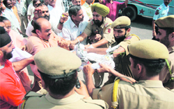 Activists of the BJP clash with policemen during a protest in Jammu on Sunday