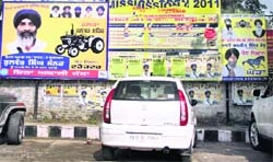 Posters of candidates for the SGPC polls can be seen on walls in the Model Town market in Jalandhar. 
