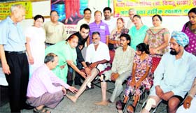Limbs being distributing free of cost among the handicapped at a camp organised by the Bhartiya Vikas Parishad at Viklang Kender, Rishi Nagar, Ludhiana, on Sunday.