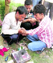 A tattoo artist at work at Chhappar Mela on Sunday.