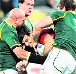 Wales Michael Phillips (C) is tackled by Springbok CJ van der Linde (L) and Willem Alberts during the 2011 Rugby World Cup Pool-D match in Auckland on Sunday. South Africa won 17-16