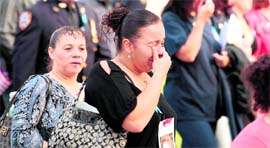 A woman breaks down as she enters the 9/11 Memorial Plaza at the World Trade Centre site.