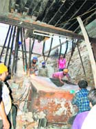 Residents dismantle the paapar-drying machine to rescue the trapped persons from the debris of the building which collapsed in Amritsar on Monday. 