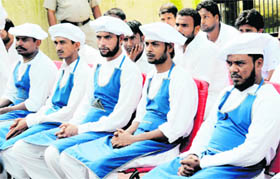 Jail inmates dressed in cooks uniform all ears to a cookery lesson at Model Jail in Chandigarh on Monday. 