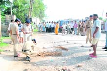 Police officials examine the spot where Deputy Jailer Narendra Singh Thapa was shot dead in Roorkee on Monday. 