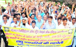 Street vendors stage a protest in Haridwar on Monday