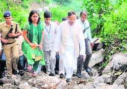 Chief Minister BC Khanduri visits the landslide site near Narendernagar in Tehri Garhwal on Monday. Six persons were killed in the landslide. 