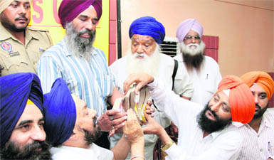 Lok Bhalai Party president Balwant Singh Ramoowalia returns the money that Tejinder Singh gave to a Canada-based NRI, in Jalandhar