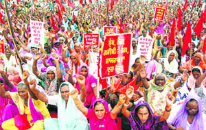Activists of the Pendu Mazdoor Union protest in Jalandhar on Monday.