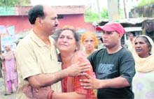 Relatives of Babita (inset), who was crushed to death at Rama Mandi Chowk, console her mother in Jalandhar on Monday. 