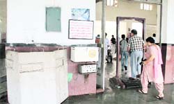 Visitors pass through the lone electronic metal detector at the railway station in Jalandhar.