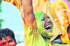 Devotees play with colours on the banks of Sutlej on the occasion of Ganesh Visarjan in Ludhiana. 