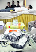A volunteer donates blood during a blood donation camp organised at MBD Mall in Ludhiana. 