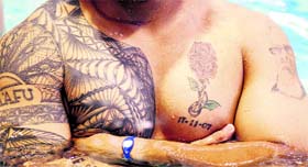Australias rugby player Salesi Maafu flaunts his tattoos at the World Cup in Auckland on Monday.