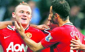 Manchester Uniteds Wayne Rooney (L) celebrates his third goal against Bolton Wanderers in the EPL game in Bolton on Saturday.