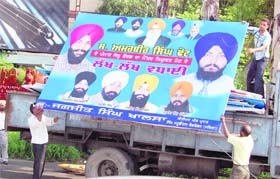 A political hoarding being removed from the roadside in Amritsar