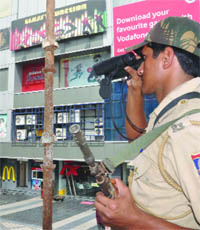 A policeman keeps a vigil outside the V3S mall at Vikas Marg in New Delhi 
